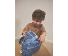 Load image into Gallery viewer, Child opening a blue backpack with a white interior