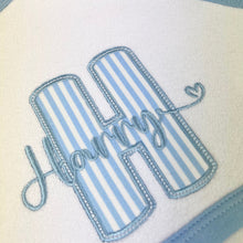 Load image into Gallery viewer, Embroidered name on a blue and white striped fabric with decorative border
