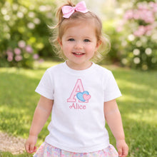 Load image into Gallery viewer, Child wearing a white t-shirt with a letter 'A' and name 'Alice', standing outdoors.