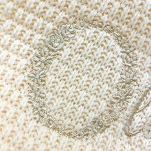 Load image into Gallery viewer, Close-up of a textured beige fabric with floral embroidery