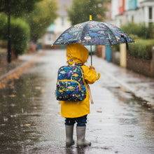 Load image into Gallery viewer, Child in yellow raincoat with colorful backpack and umbrella walking on a rainy street.