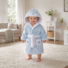 Load image into Gallery viewer, Baby in a blue hooded robe with bear design standing on a carpeted floor.