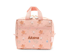 Load image into Gallery viewer, A pink insulated lunch bag with a whimsical fairy and pumpkin pattern, featuring the name 'Aitana' printed on the front, set against a plain white background.