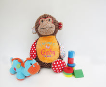 Load image into Gallery viewer, Brown patchwork Monkey Soft toy. He has one multicoloured polka dot ear, arm and foot, the other Ear, arm and foot is red with large polka dot. he has a brown corduroy body with an orange belly that has been personalised with "I belong to Gaby" a butterfly and love hearts embroidered on its belly. He has small embroidered black eyes and a big cheeky smile