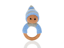 Load image into Gallery viewer, Blue wooden &amp; crochet teething ring rattles. The wood ring is half wrapped with crocheted cotton, a cute head sits on top of the wooden ring with stitched black eyes and a matching bobby hat